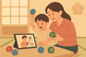 親子が動画を見ながらお手玉を練習している様子
